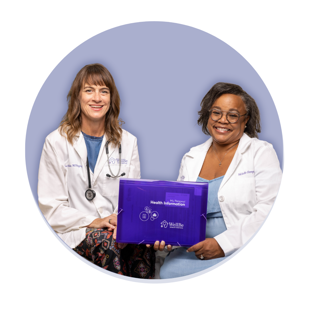 two WellBe nurse practitioners smile while holding a packet of WellBe information