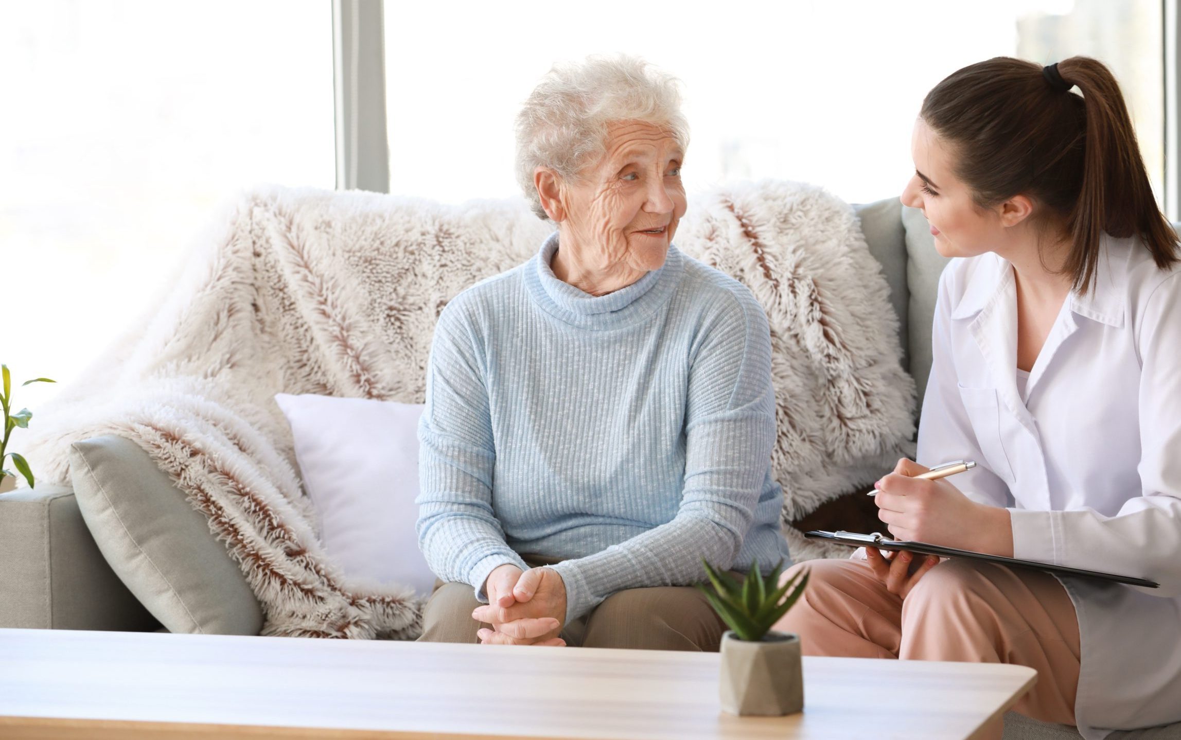 Caregiver with elderly patient at home
