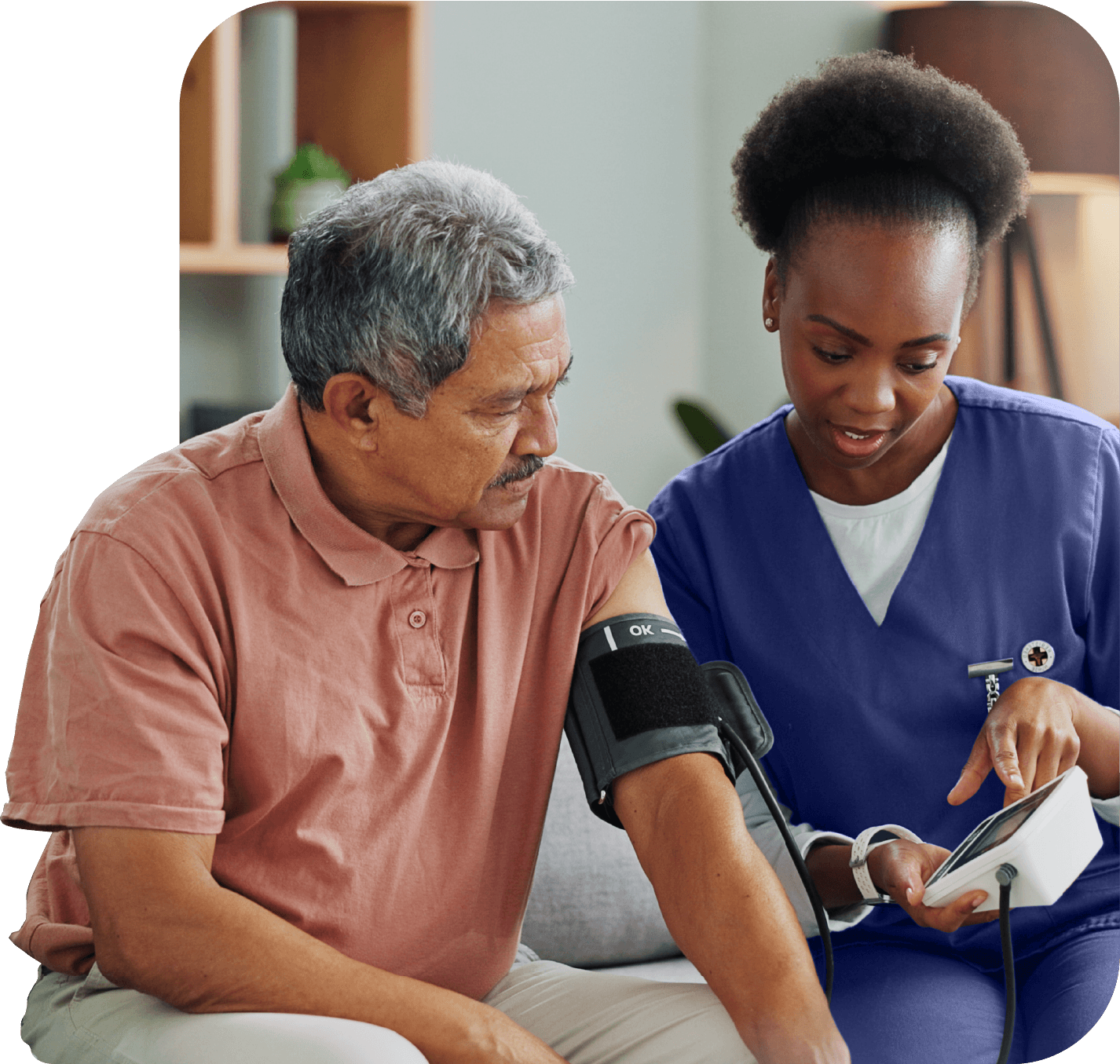 Doctor taking patient blood pressure at home